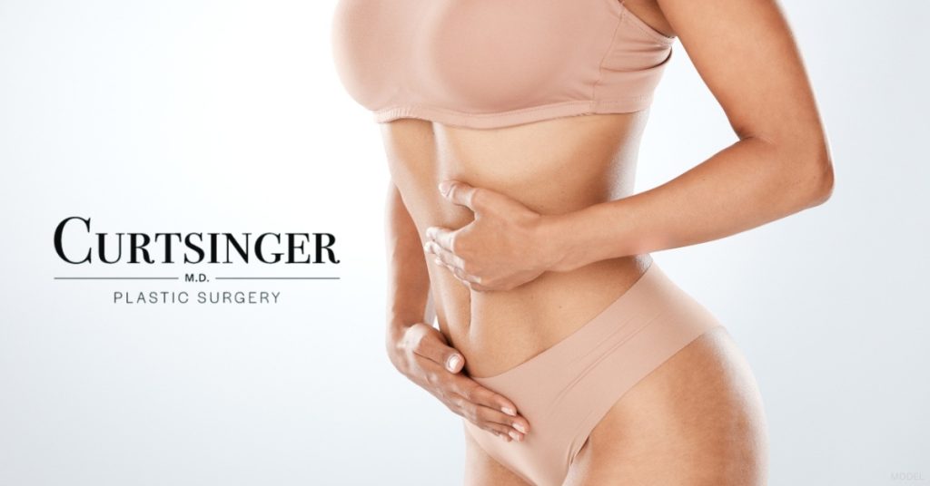 a woman with her hands on their stomach (model) Dr. Curtsinger Logo