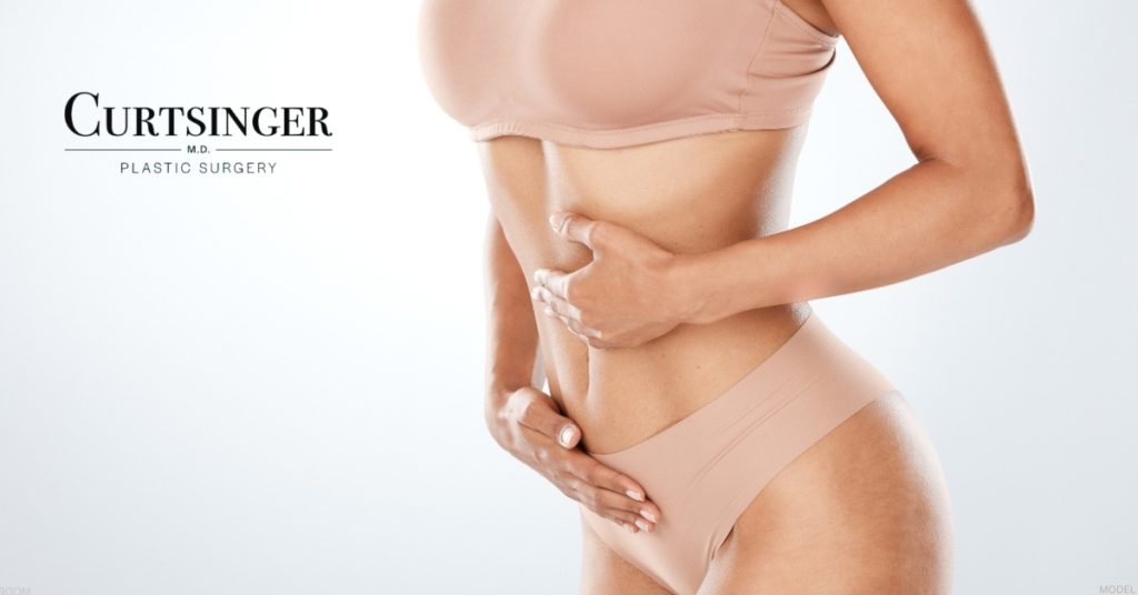 Women showcasing mommy makeover results (model) Dr. Luke Curtsinger Logo
